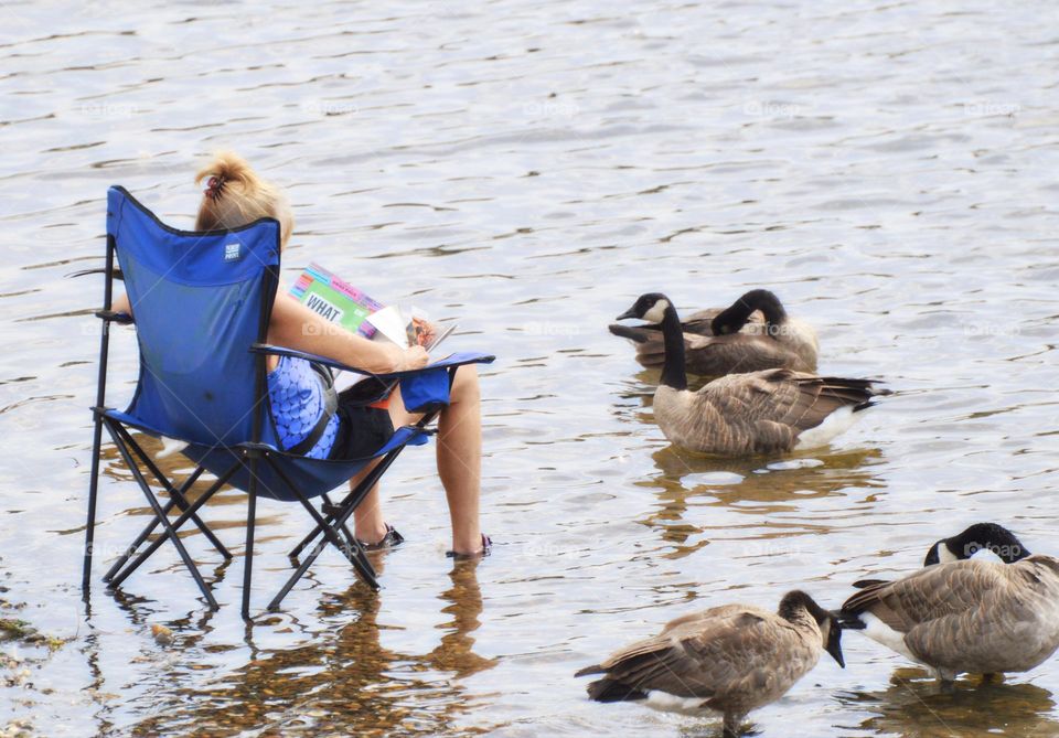 sitting in the water reading to Nature while keeping cool