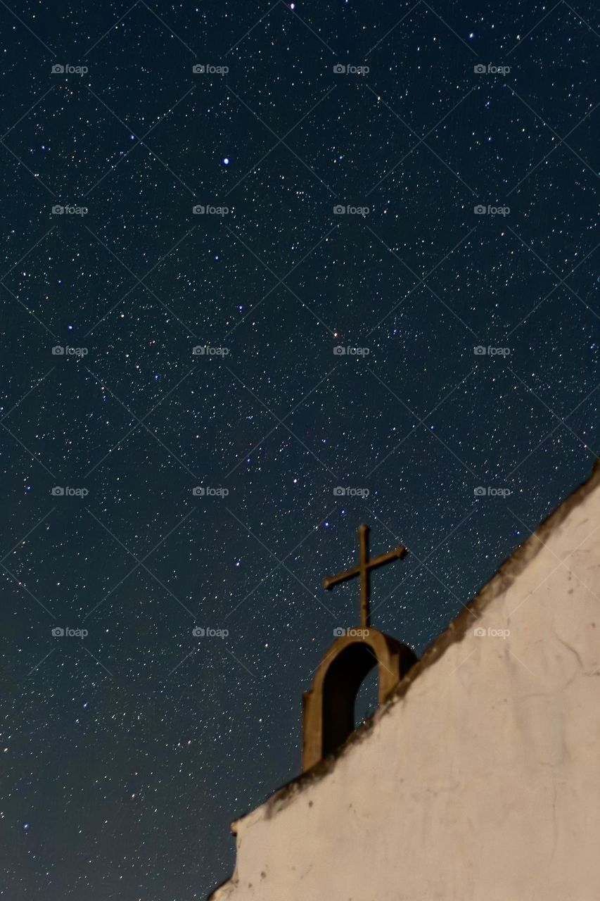 An old disused church shares the night sky with hundreds of stars