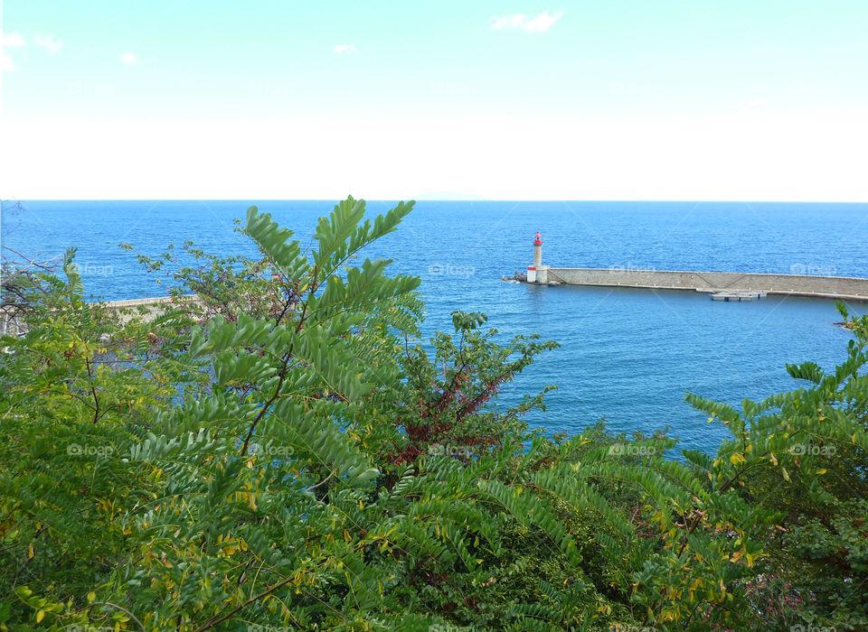 view down to the sea and a little harbor basin at Corsica