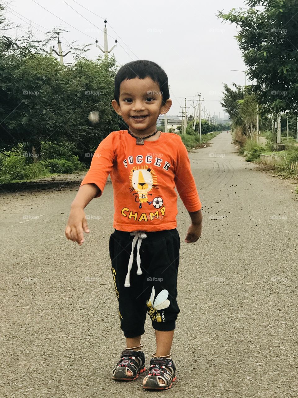 Indian baby boy playing on road 