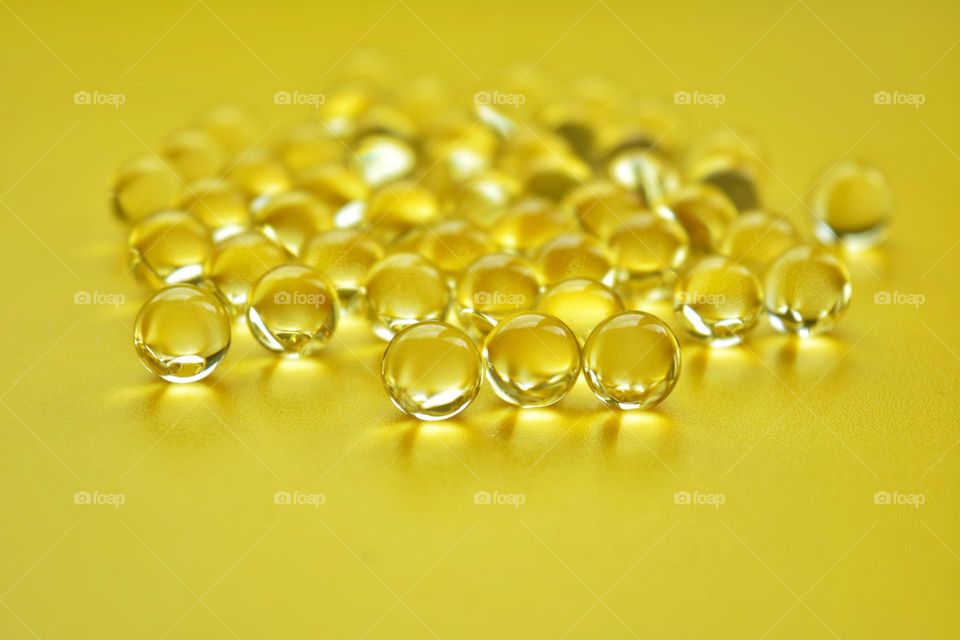 vitamins capsules oils round beautiful texture yellow 💛 background