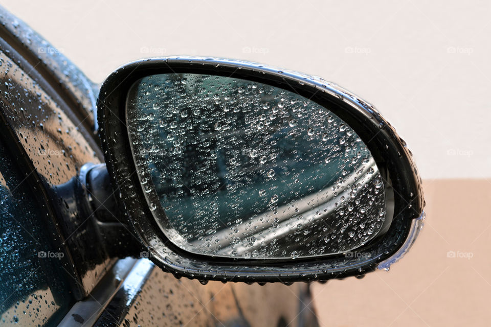 Raindrops on the car side mirror