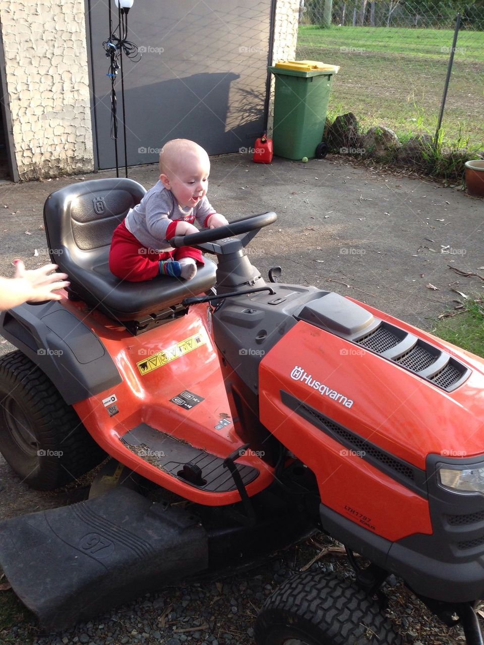 Baby having fun a lawnmower 