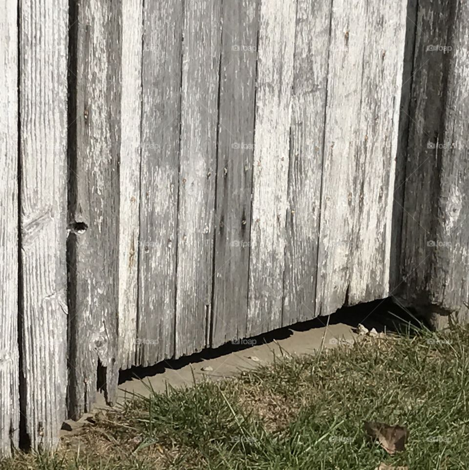 Gap at the bottom of a door of an old shed