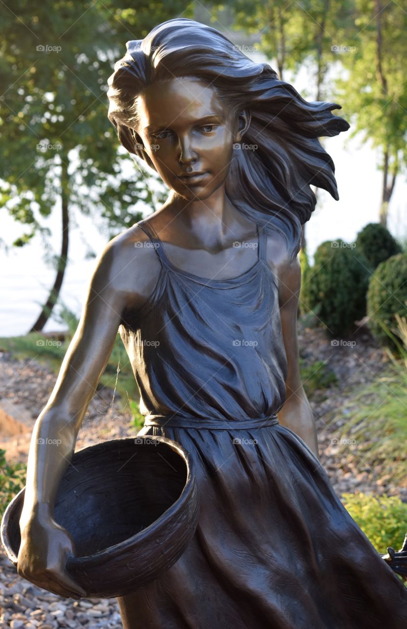 Backlit Bronze Statue by River