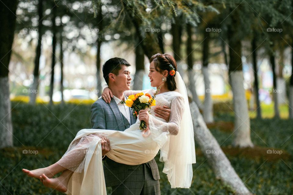 Freshly married couple is outside to celebrate their time in the beginning of warm days