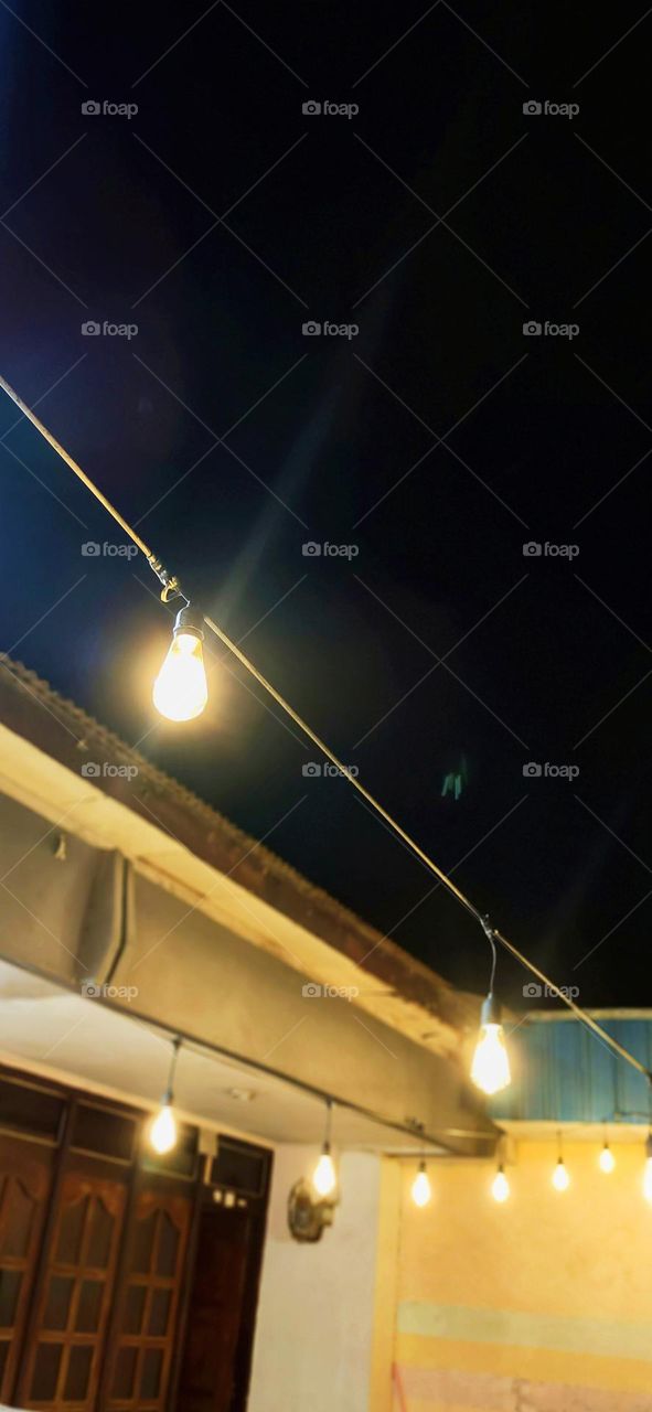 Courtyard lights are turned on at night. Night view in the yard