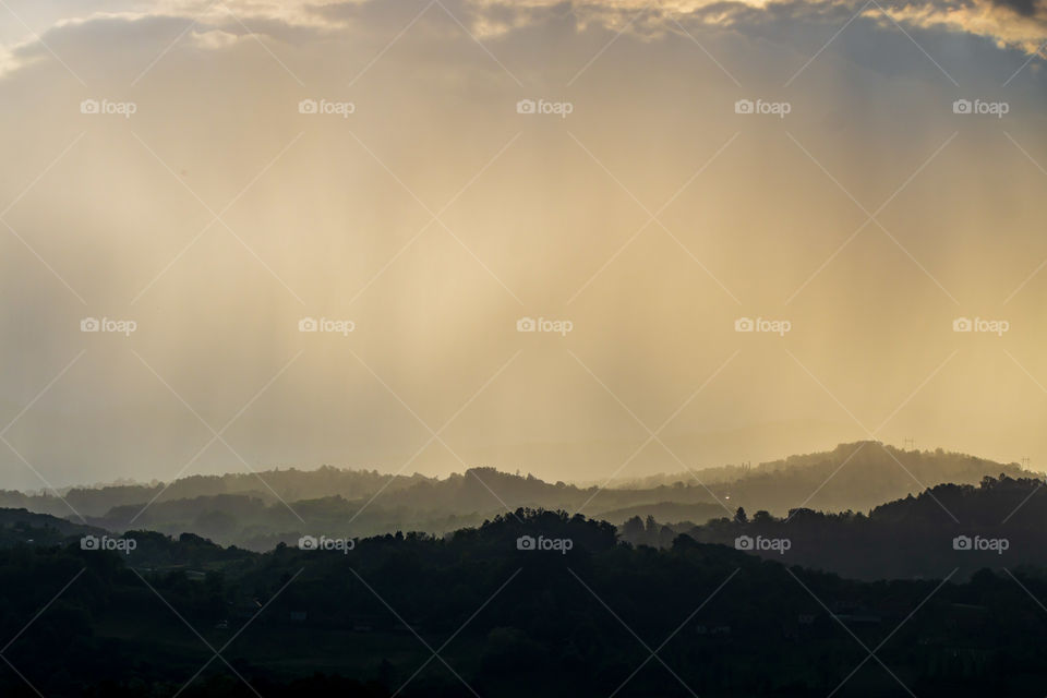 Sun rays with rain on hills in west Serbia