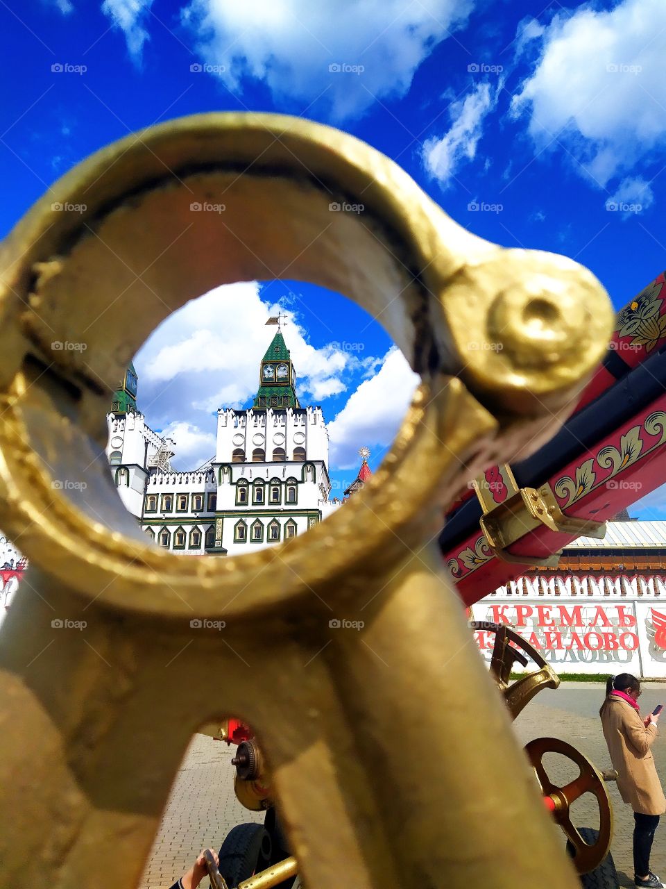 One of the towers of the castle through a metal ring of a decorative anti-aircraft gun