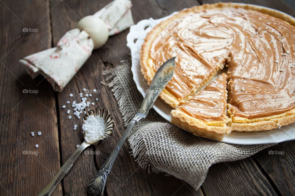 Caramel tart on the wooden table 