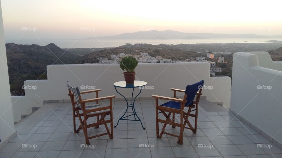 Beautiful balcony with amazing view of the island of Naxos.  All the furniture you need and a pot of Basil.  You can also  see the neighborhood island of Paros in depth.