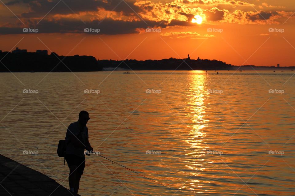 Fishermen fishing at the confluence of the Sava River and the Danube