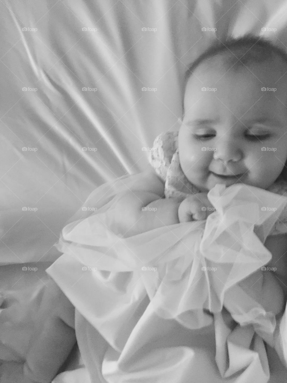 High angle view of a baby lying on bed