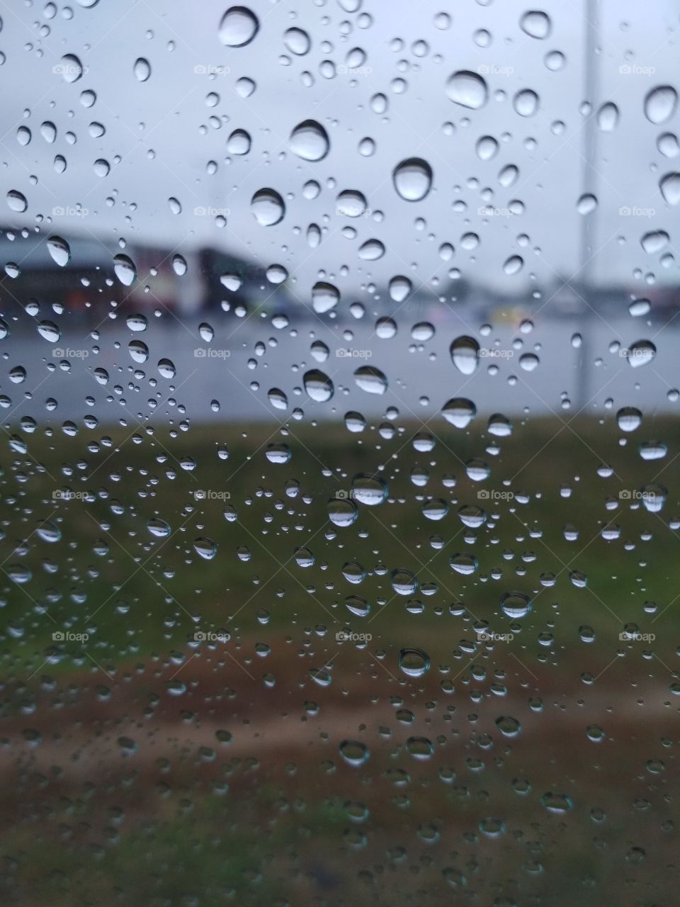 Rain production on the window in the car