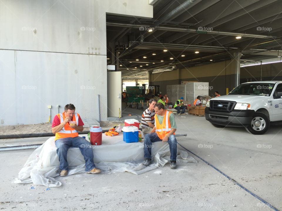 Lunch brake. Workers having lunch on construction site, Miami, Florida, USA 