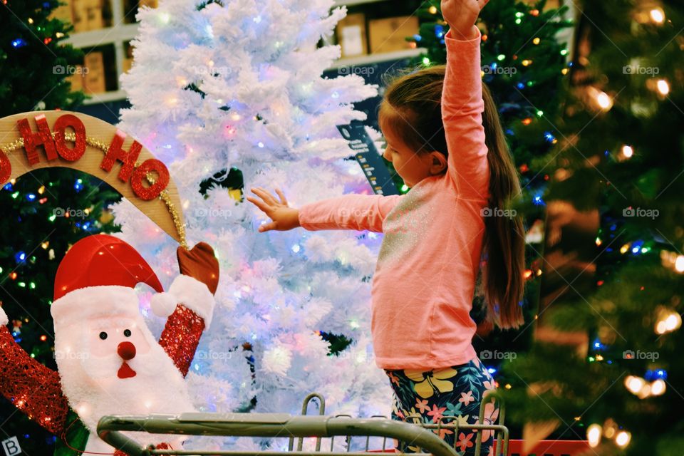 Girl standing near christmas tree