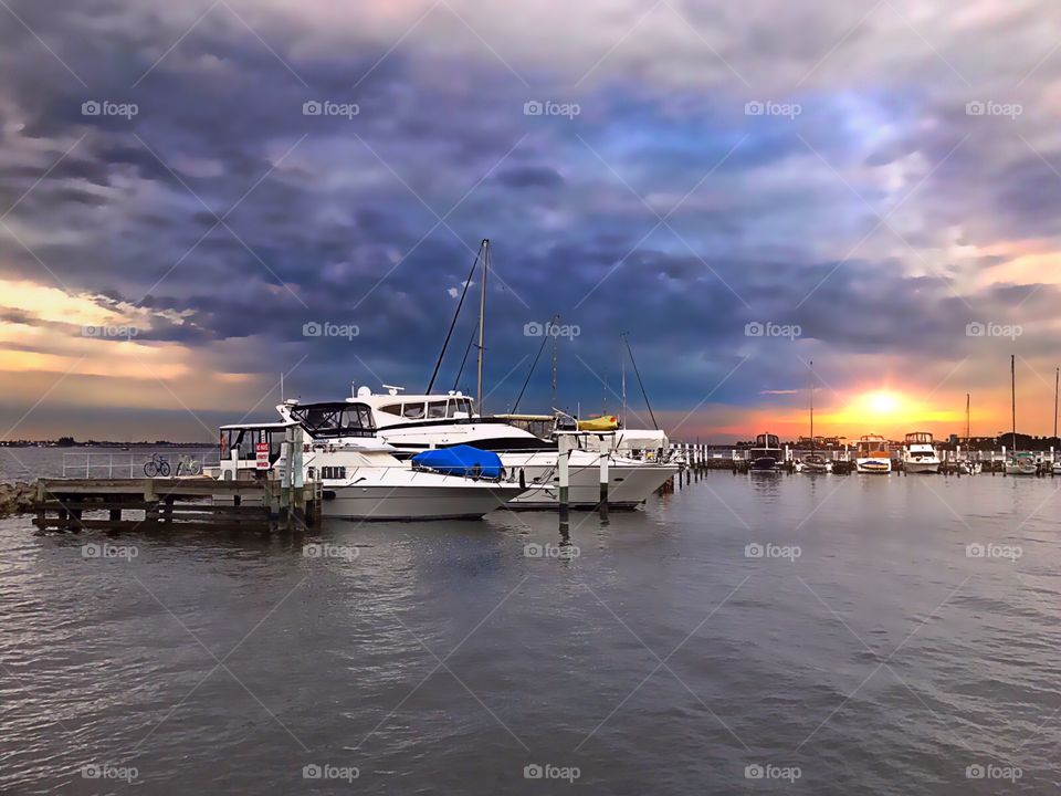 Beautiful sunset behind the boats at the marina.