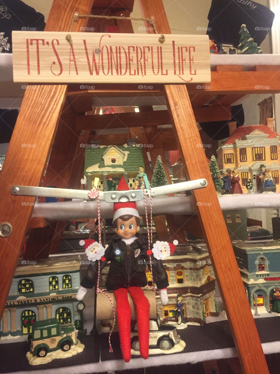 Elf on the shelf swinging in Bedford Falls