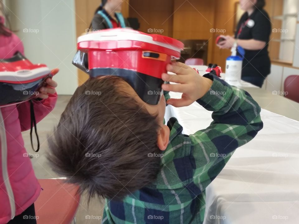 boy using virtual reality master viewer goggles