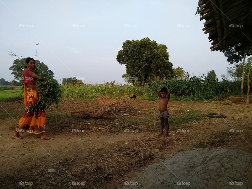 poor people life in village, grandson and grany in the picture. clean environment life in village.