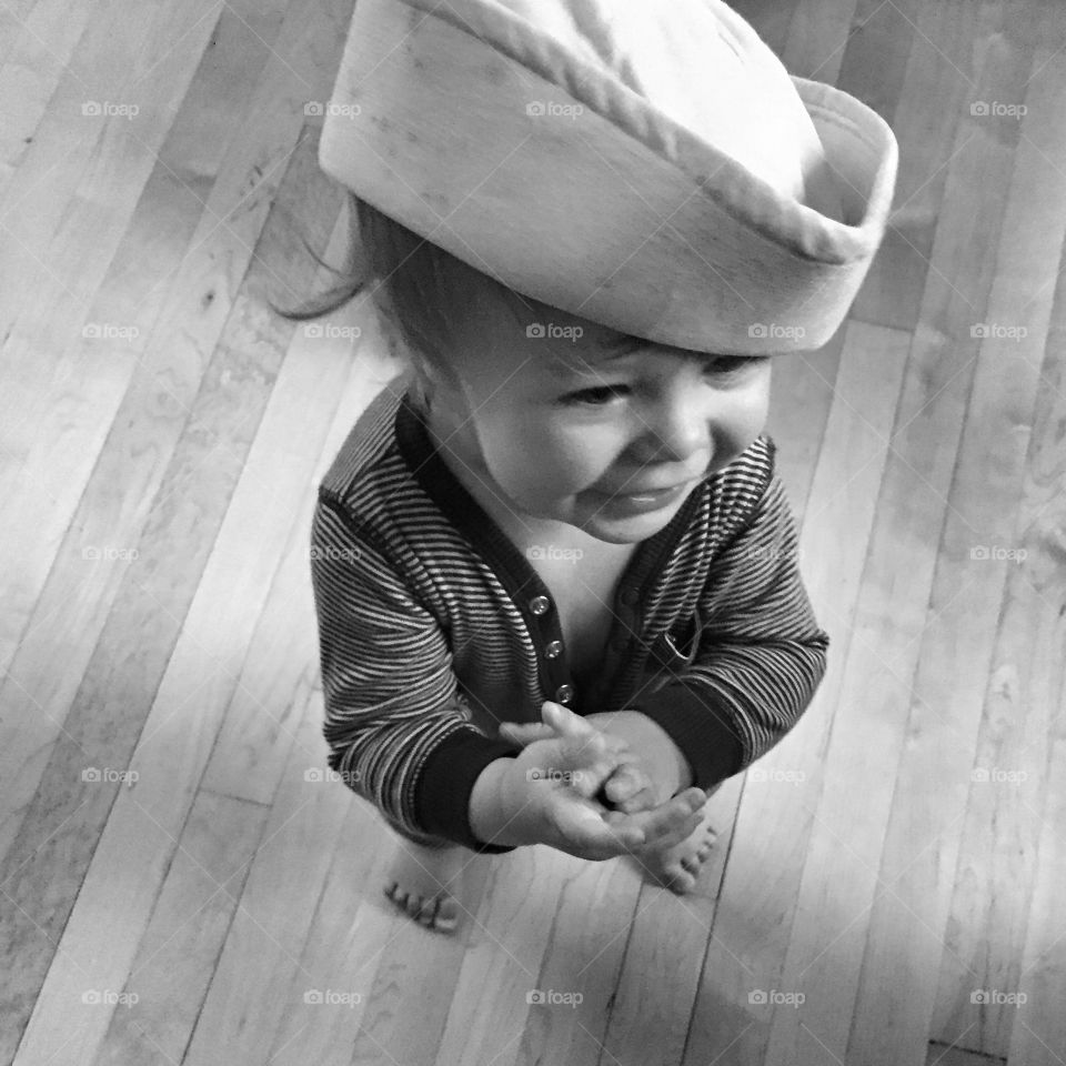 High angle view of a little girl standing on wooden floor