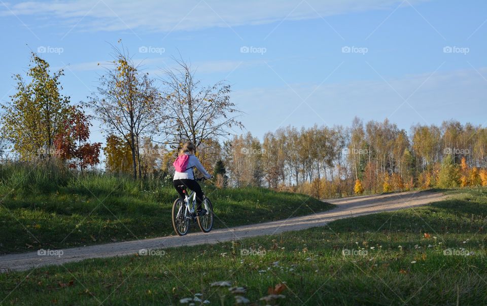 person riding on a bike autumn landscape, social distance