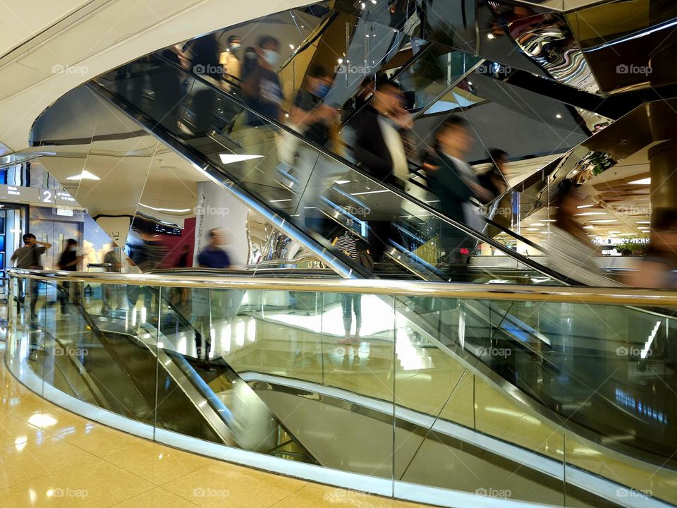 People going up and down in escalators