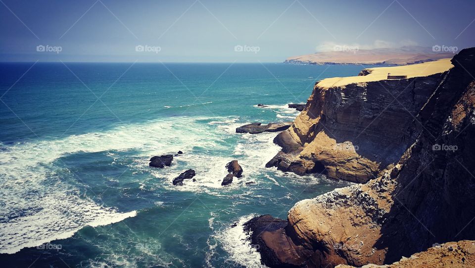 Ocean waves crash against the Peruvian coastline