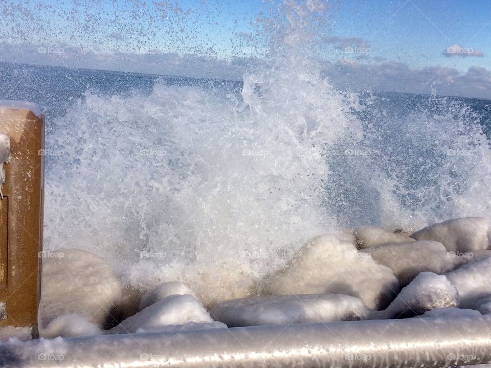 Splashing water on icy rocks 