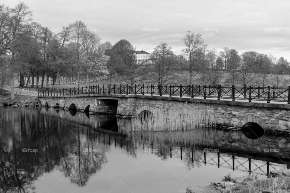 black and white photograph of the bridge and river at Nääs Slott captured in a long exposure photograph