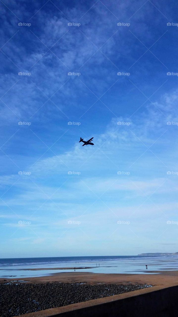 Plane flying over Westward ho beach