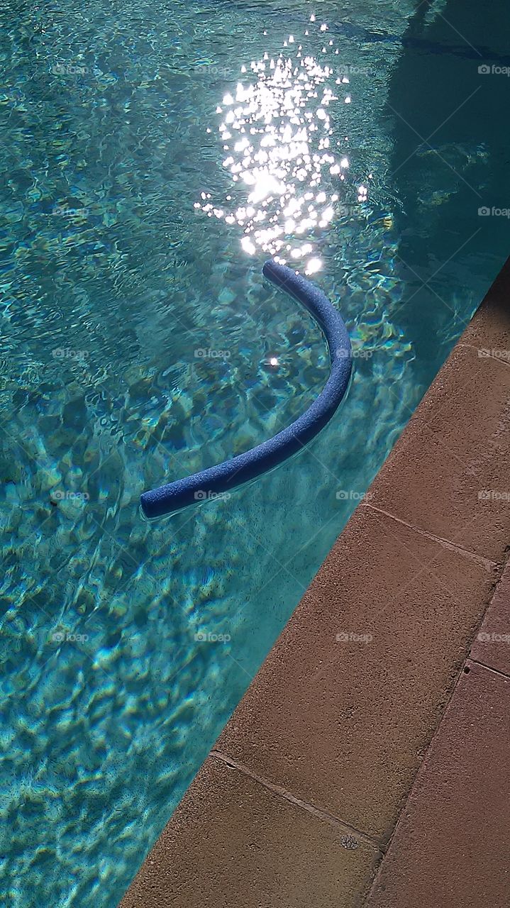 Blue floatie. Morning time at the pool