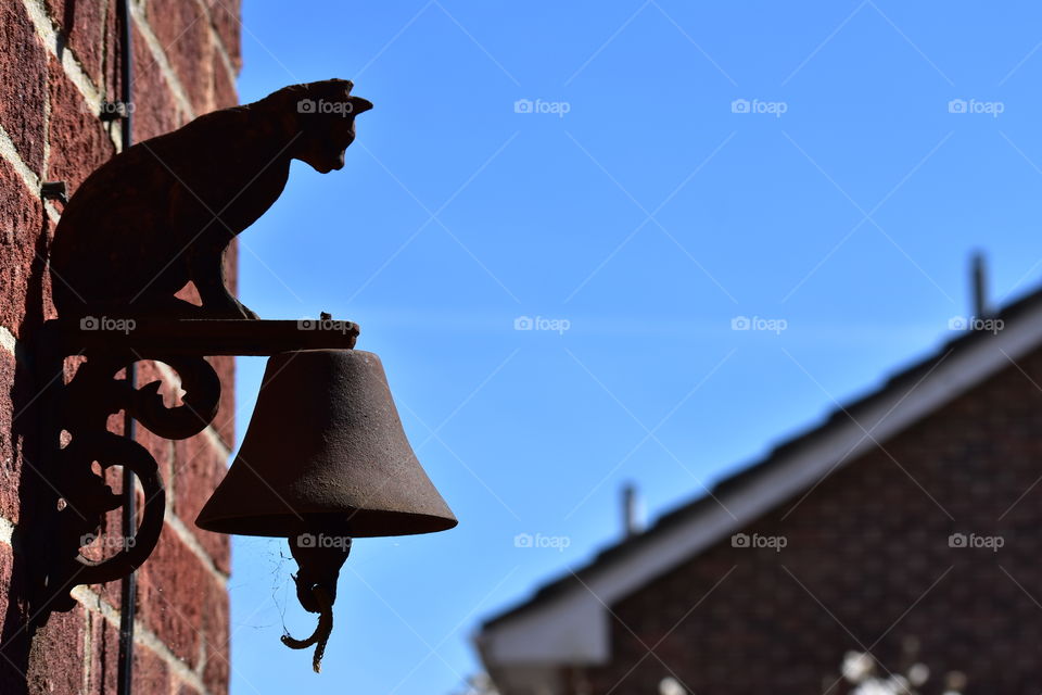 Rusty house bell with clear skies