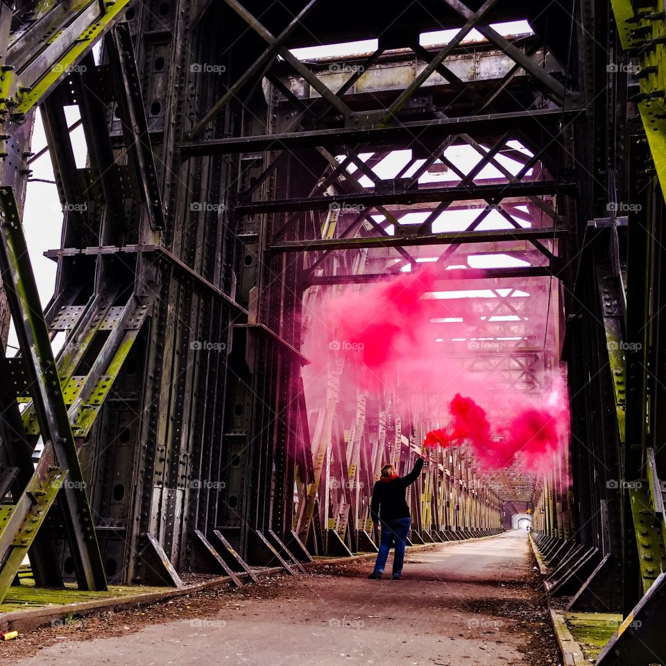 Rear view of a woman holding distress flare