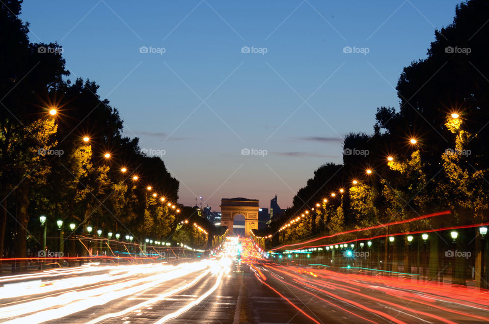 Traffic flowing under the arc de triumph in Paris
