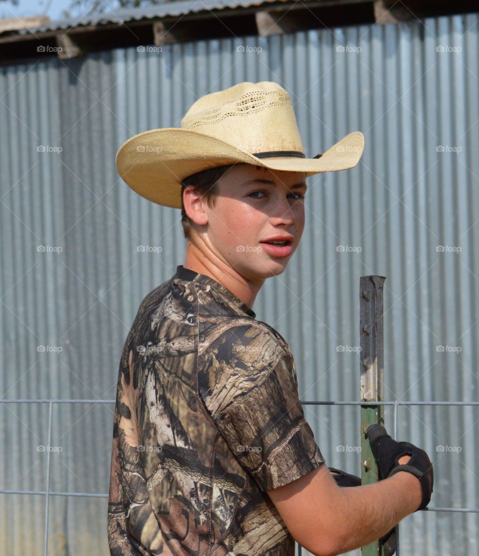 Teenage boy wearing cowboy hat