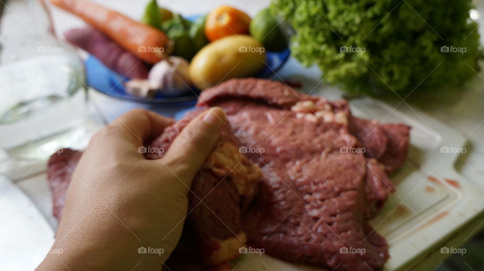 woman cooking beef with vegetables