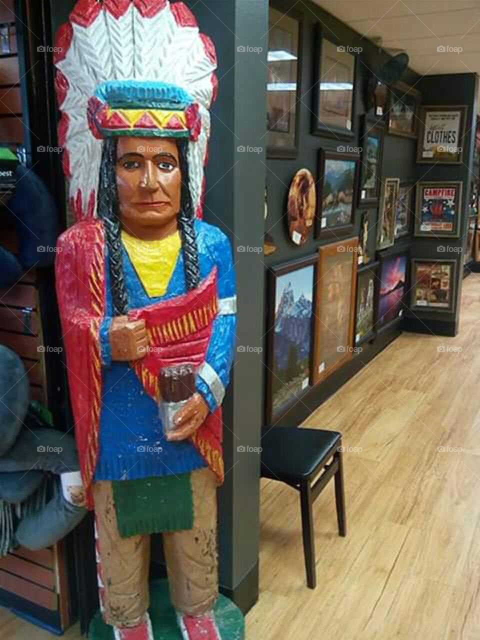hand carved painted statue of native American in gift shop