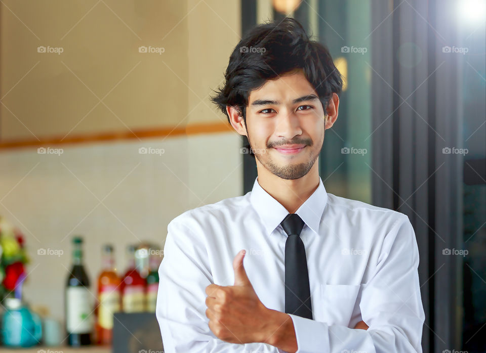 Portrait of asian young man showing thump-up