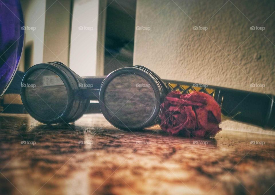 Goggles rose on marble countertop