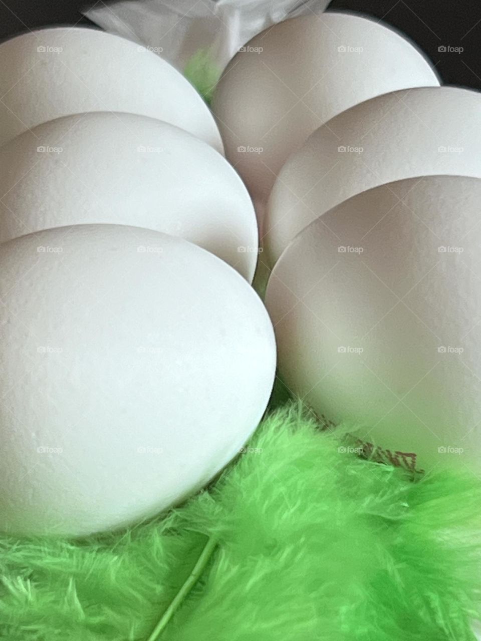 What is Easter eggs laying on a bed of green feathers?