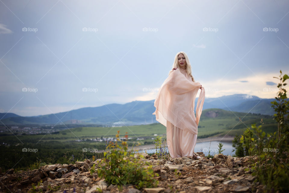 Beautiful woman posing on hill