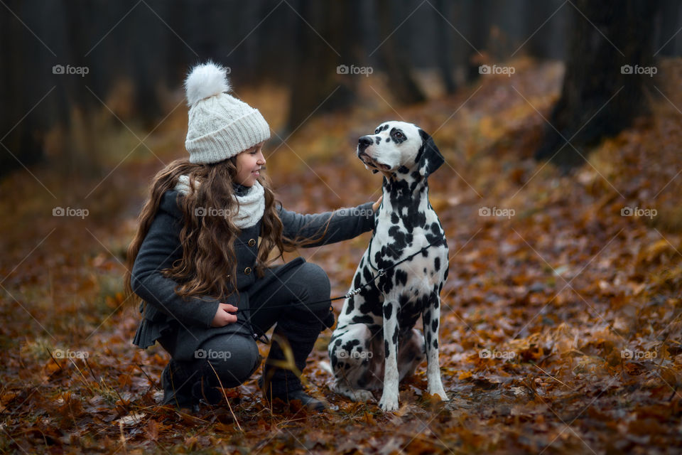 girls with Dalmatian dogs in autumn park 