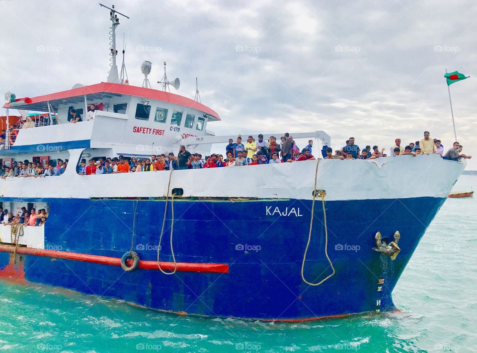 A giant ship reached his destination and all the people were eagerly waiting for the ferry. Cloudy weather makes the atmosphere really amazing. 