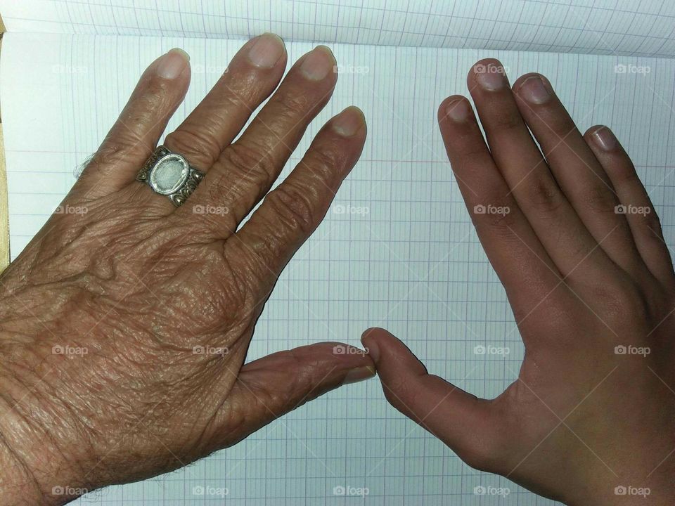 Old hand beside young hand