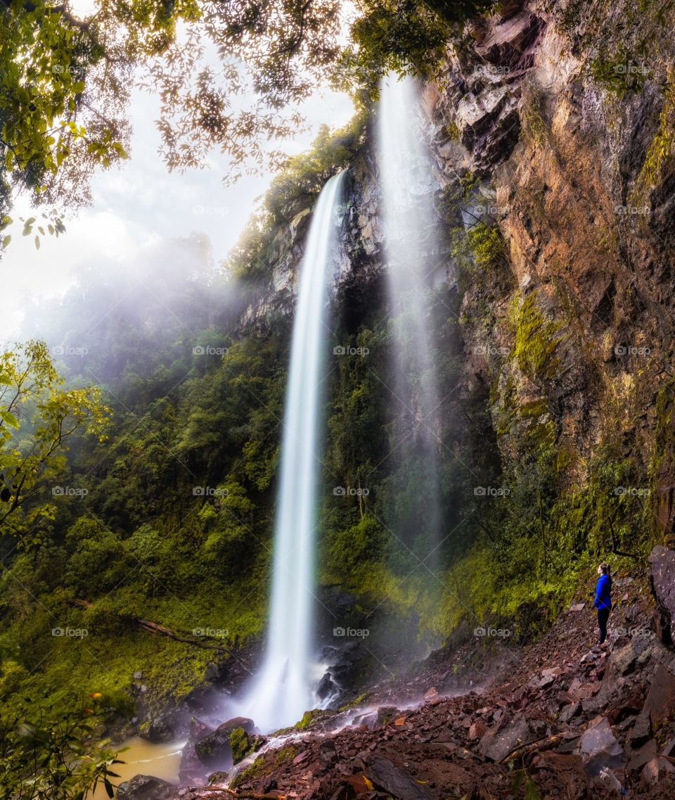 Girl looking at the waterfall