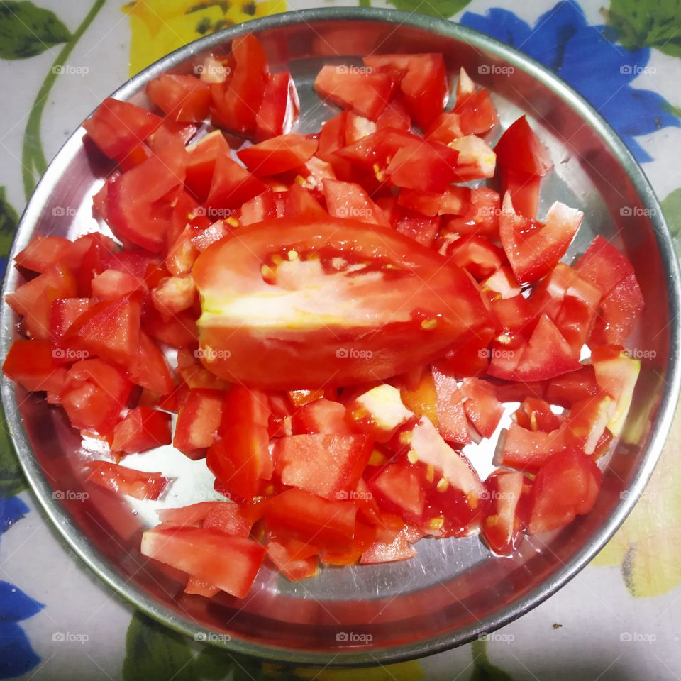 fresh tomatoes cut into pieces. Have bright red. look delicious