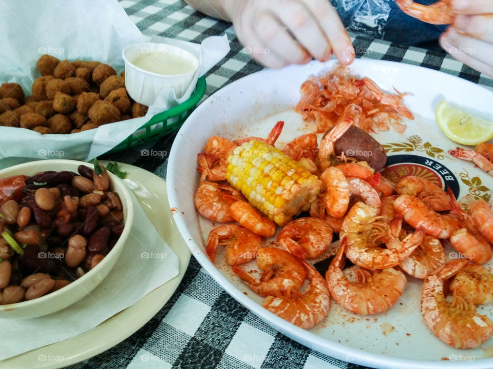 Close-up of person hand preparing seafood