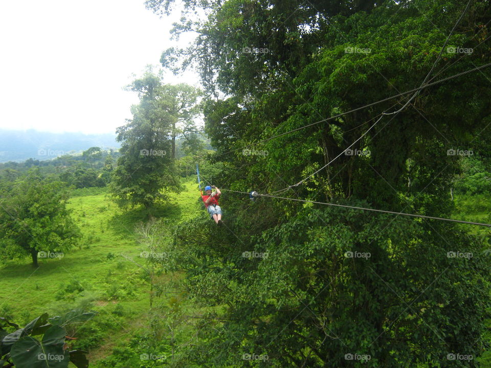 the final zip line down the mountain and forest of Costa Rica Arenal volcano.