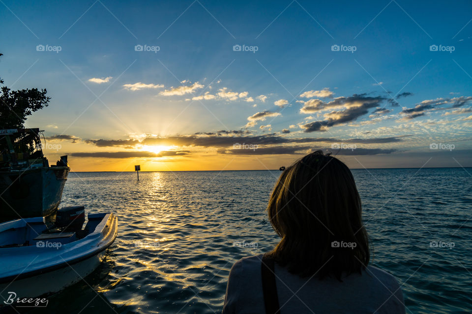 Closeup of woman looking at sunset over the sea